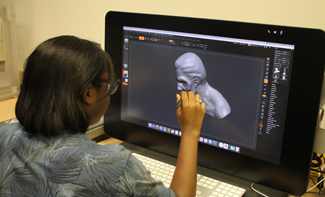 student drawing on a Wacom tablet