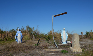 Virgin Mary statues in an empty field