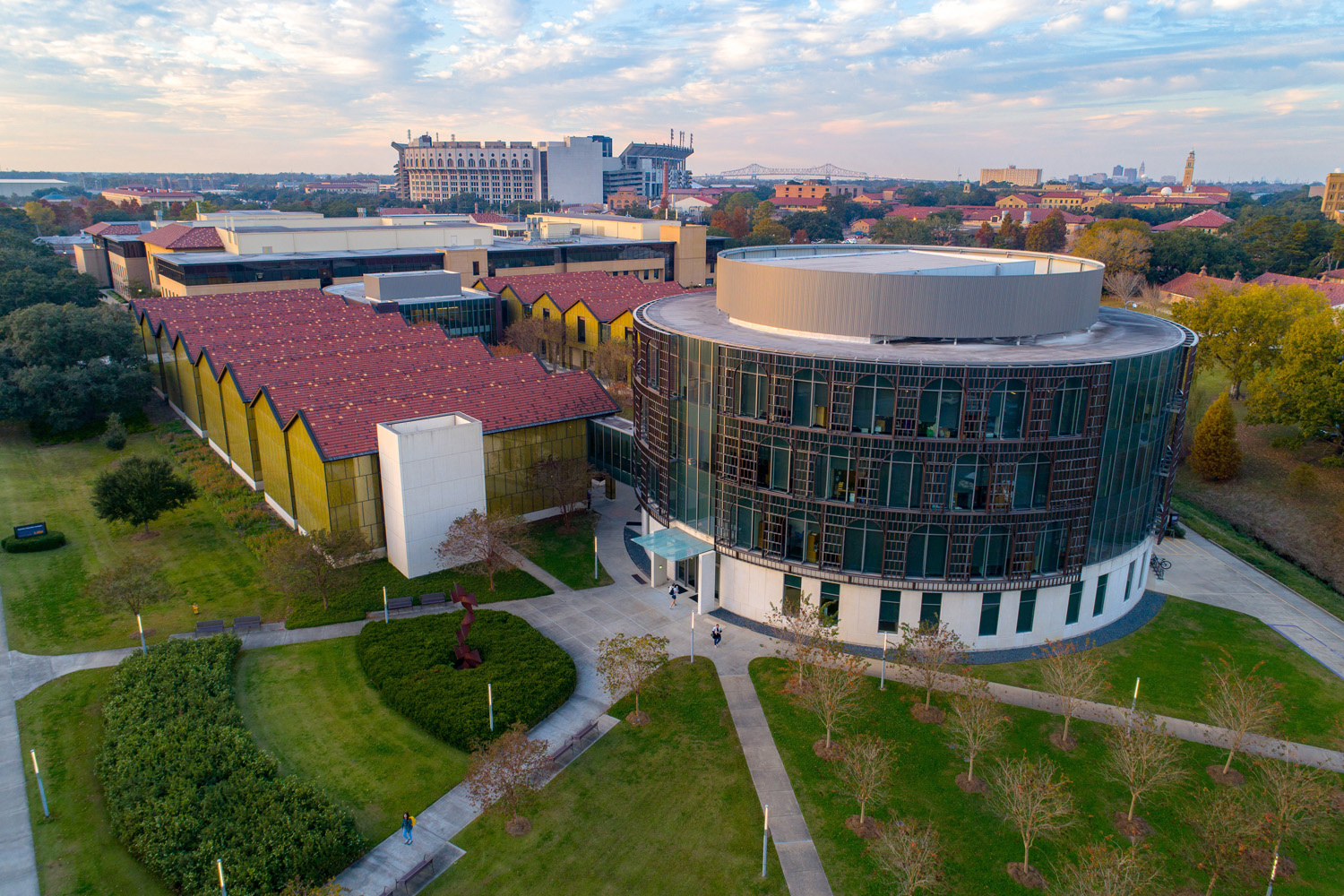 Aerial photo of the Business Education Complex. There is a round Rotunda in the forefront and Tiger Stadium is in the background. 