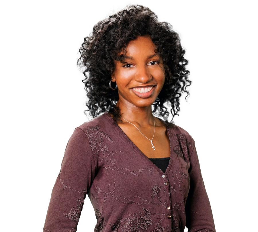 Reya Machen is in a purple shirt and holding up her hand in the shape of an L