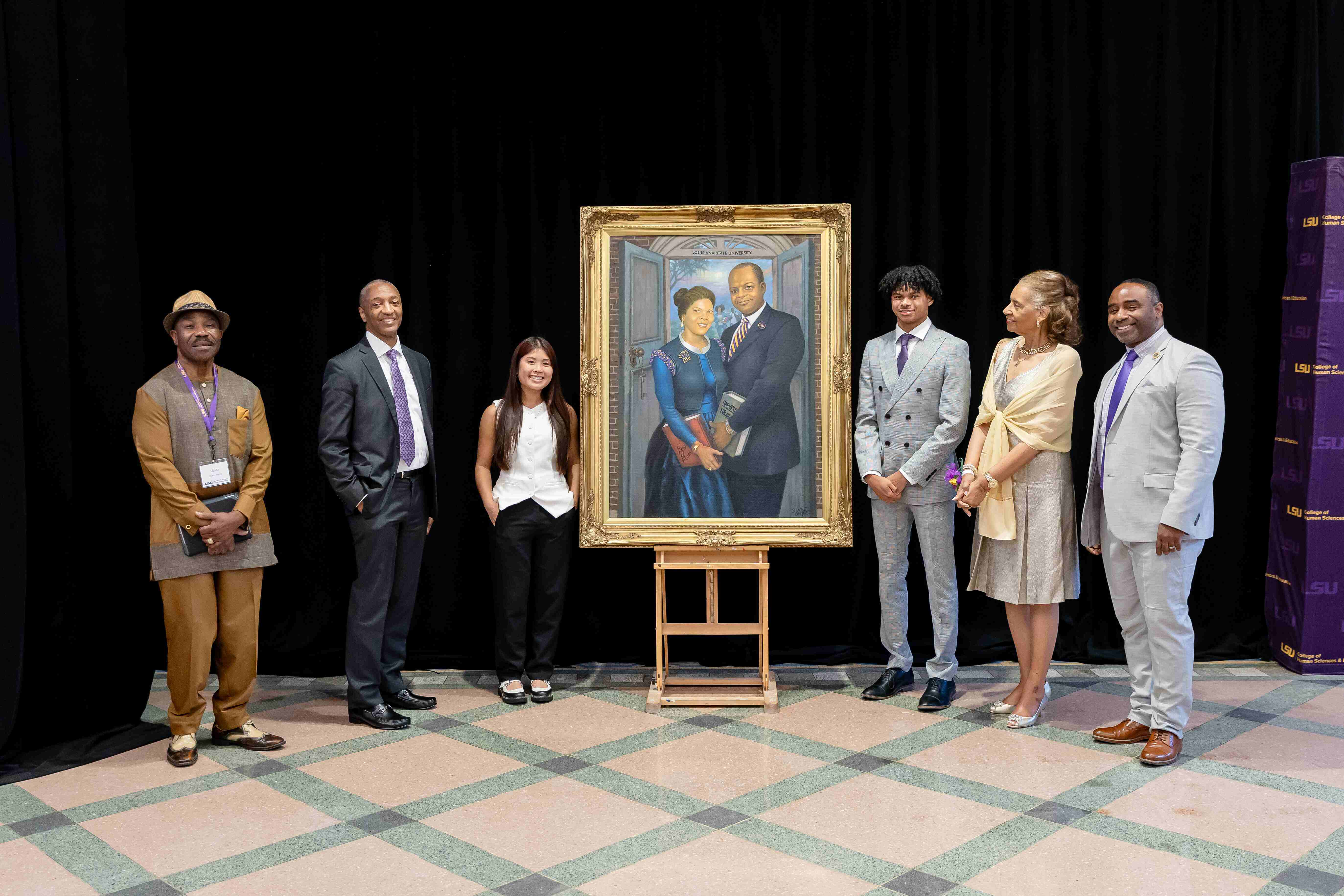 Group photo with painting of Lutrill and Pearl