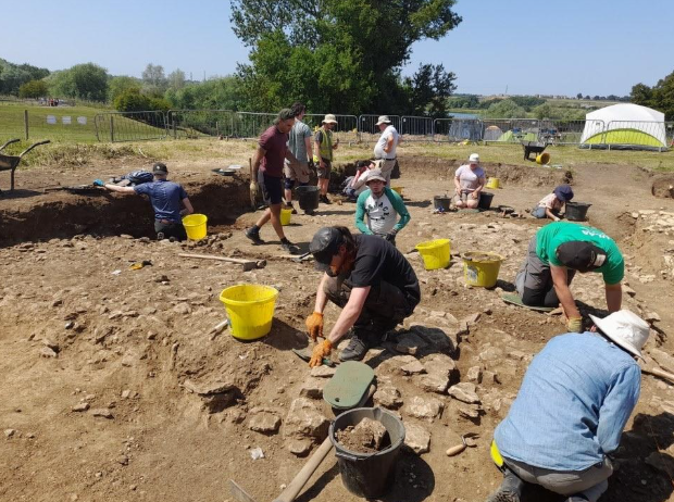 LSU student Cam Crooks (front center in black) excavating Roman age architectural features at the Irchester Field School, Northamptonshire, UK.