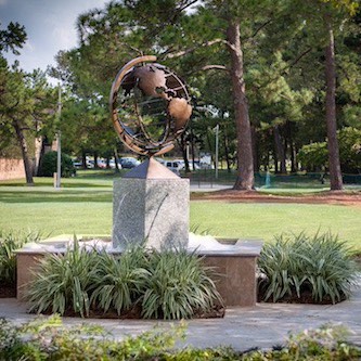 statue of globe on campus