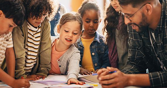 Children participating in a learning activity with an educator.