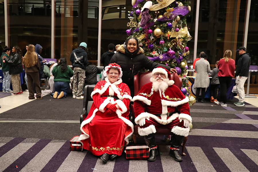 student with Santa and Mrs. Claus